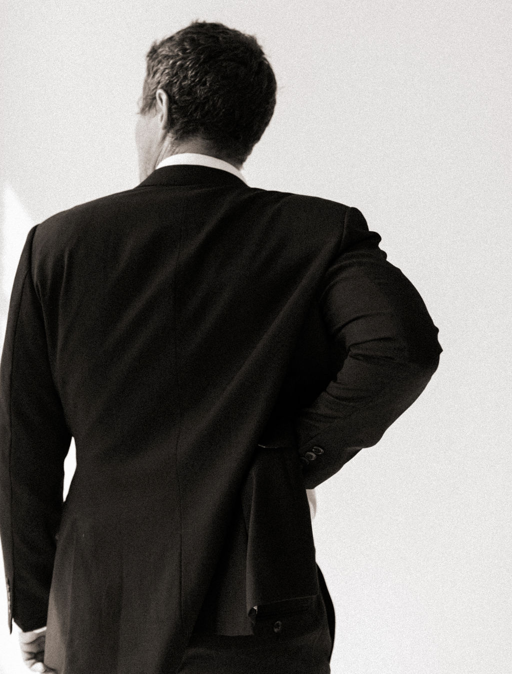 Man in a James suit by a window